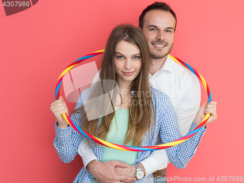 Image of portrait of happy couple with hula hoop