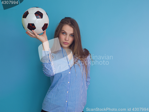 Image of young woman playing with a soccer ball