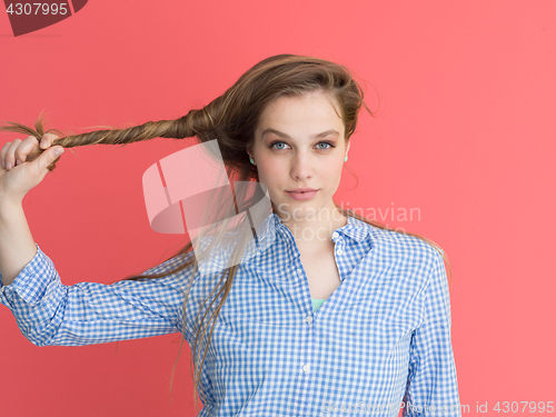 Image of woman playing with her long silky hair