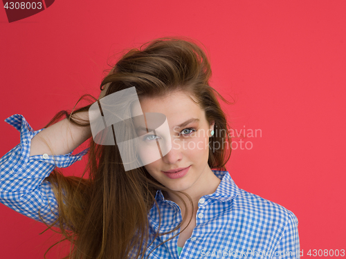 Image of woman playing with her long silky hair