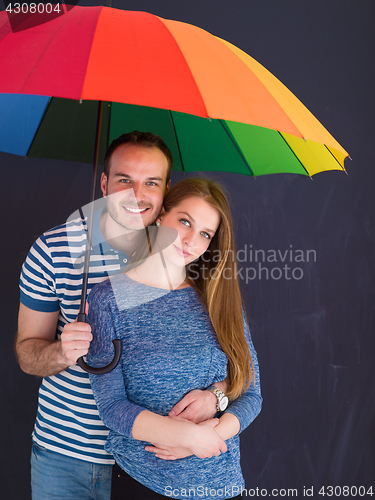 Image of handsome couple with a colorful umbrella