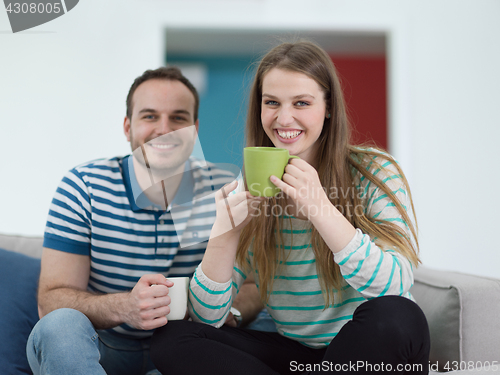 Image of young handsome couple enjoying morning coffee