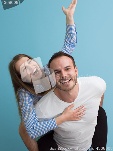 Image of young man piggybacking his girlfriend