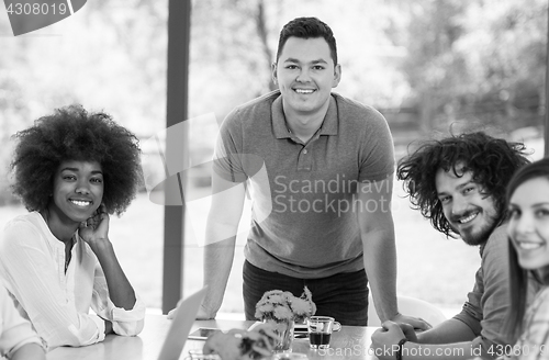 Image of Happy young team smiling at work