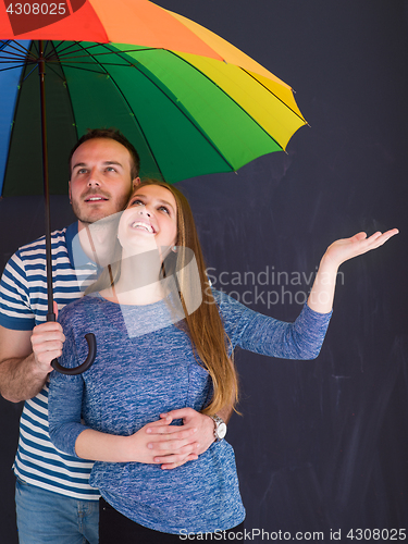 Image of handsome couple with a colorful umbrella