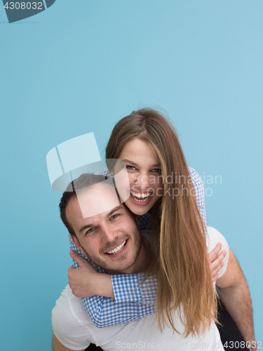 Image of young man piggybacking his girlfriend