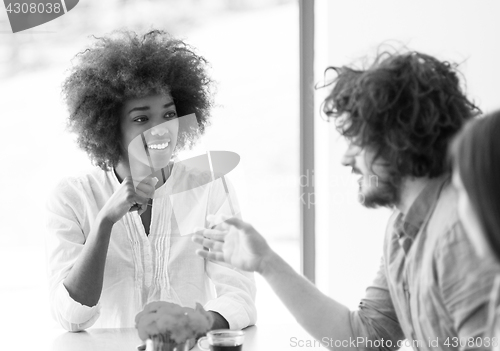 Image of Young businesswoman with her team at work