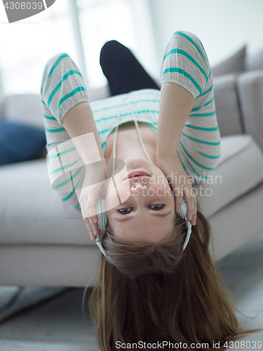 Image of girl enjoying music through headphones