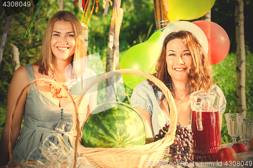 Image of Two beautiful happy middle-aged women at a picnic