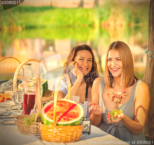 Image of beautiful laughing women at a festive table