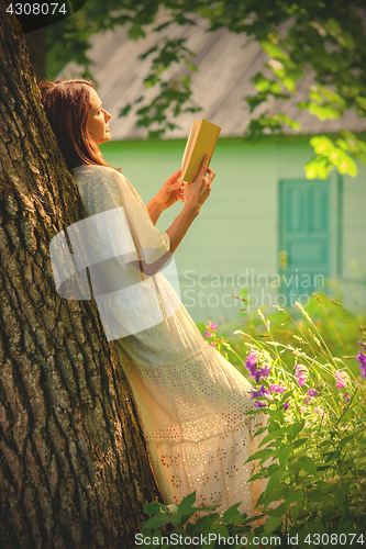 Image of beautiful woman reading a book