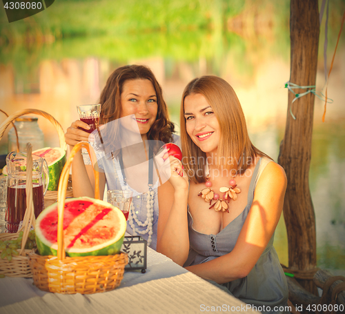 Image of Two beautiful women on a picnic