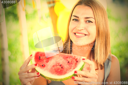 Image of smiling woman with a slice of watermelon