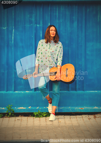 Image of fashion. Beautiful woman with a guitar