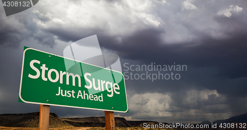 Image of Storm Surge Just Ahead Green Road Sign and Stormy Clouds