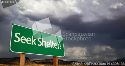 Image of Seek Shelter Green Road Sign and Stormy Clouds