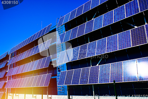 Image of solar panel against blue sunny sky        