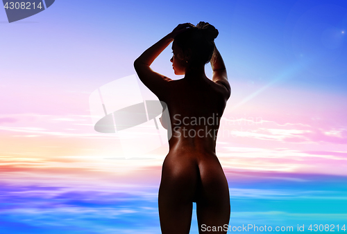 Image of silhouette of nude young woman