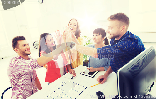 Image of creative team making high five at office