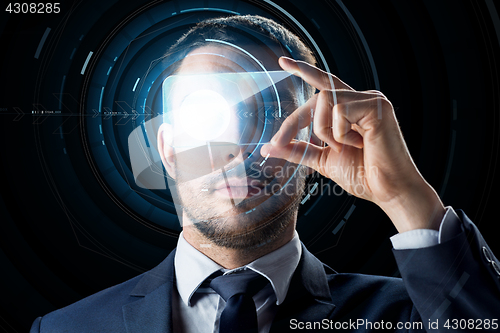 Image of businessman with transparent smartphone