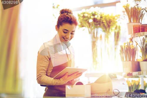 Image of woman with tablet pc computer at flower shop