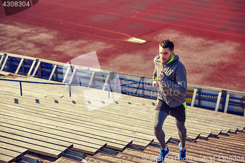 Image of young man running upstairs on stadium