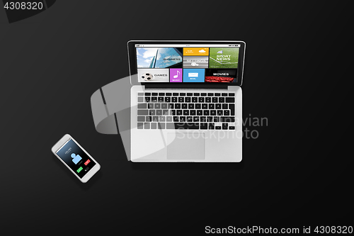 Image of laptop computer with media and smartphone top view