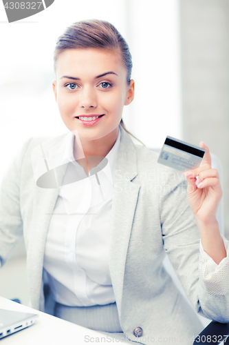 Image of businesswoman with laptop showing credit card