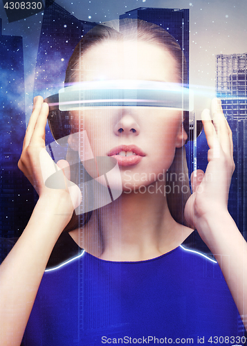 Image of woman in virtual reality glasses over space city