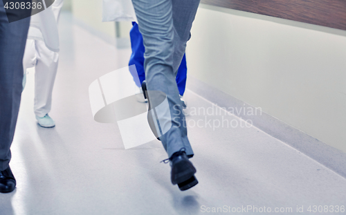 Image of close up of medics or doctors running at hospital