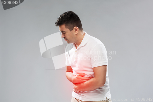 Image of unhappy man suffering from stomach ache