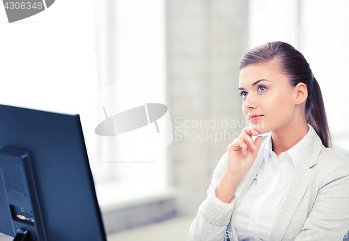 Image of pensive woman in office