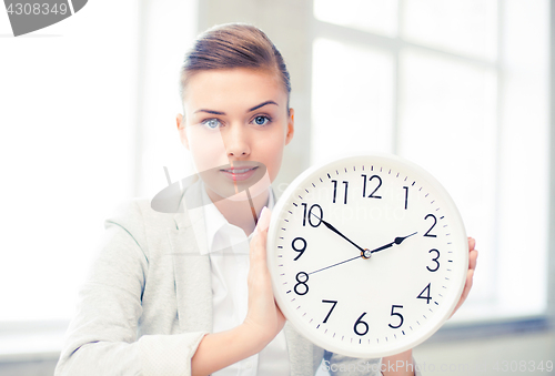 Image of attractive businesswoman showing white clock