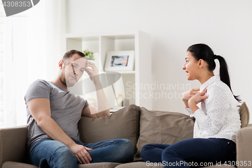 Image of unhappy couple having argument at home