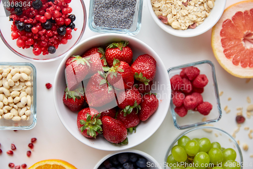 Image of fruits and berries in bowls on table