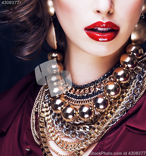 Image of beauty rich brunette woman with a lot of jewellery