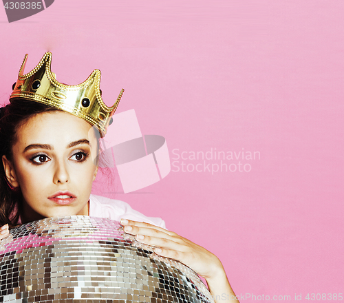 Image of young cute disco girl on pink background with disco ball and cro