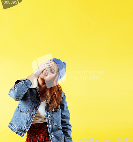 Image of young pretty teenage woman angry posing on yellow background, fashion lifestyle people concept 
