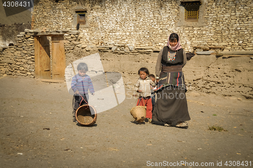 Image of Woman and children with baskets in Nepal
