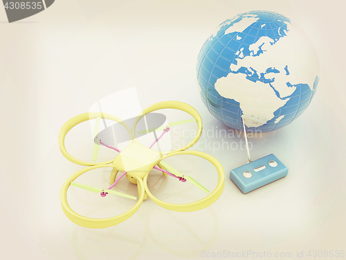 Image of Quadrocopter Drone with Earth Globe and remote controller on a w