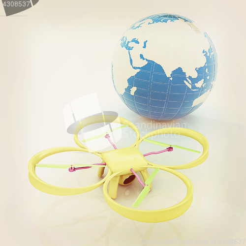 Image of Quadrocopter Drone with Earth Globe and remote controller on a w