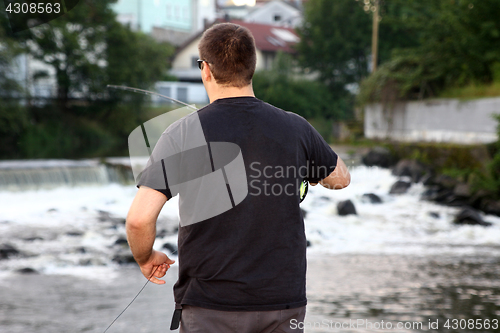 Image of Young man with fishing rod