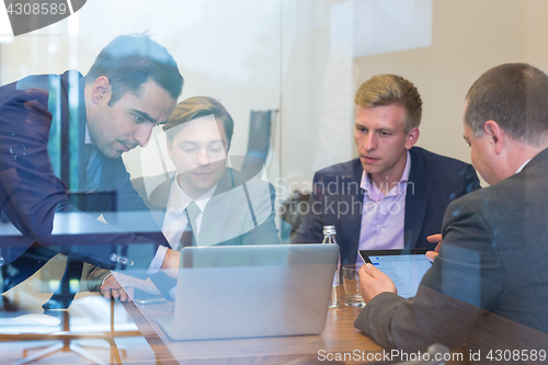 Image of Business people sitting and brainstorming at corporate meeting.