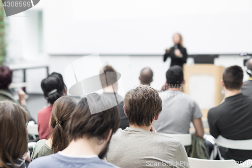 Image of Woman giving presentation on business conference.