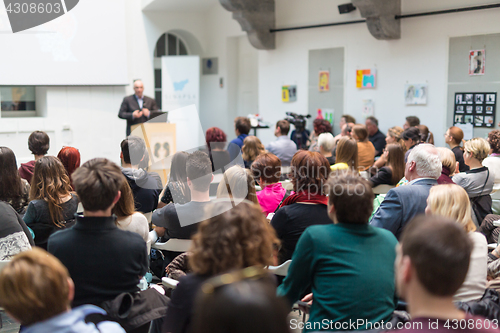 Image of Public speaker giving talk at Business Event.