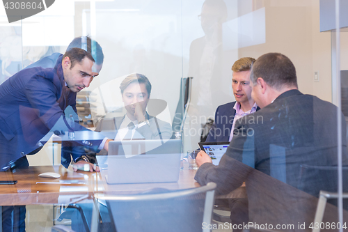 Image of Business people sitting and brainstorming at corporate meeting.