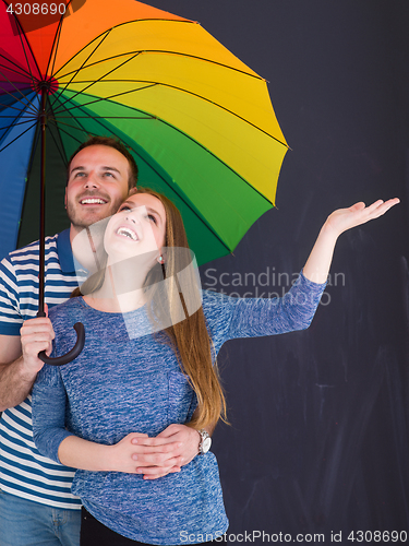 Image of handsome couple with a colorful umbrella