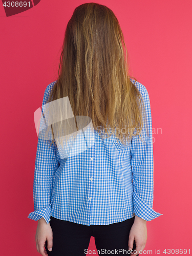 Image of woman playing with her long silky hair