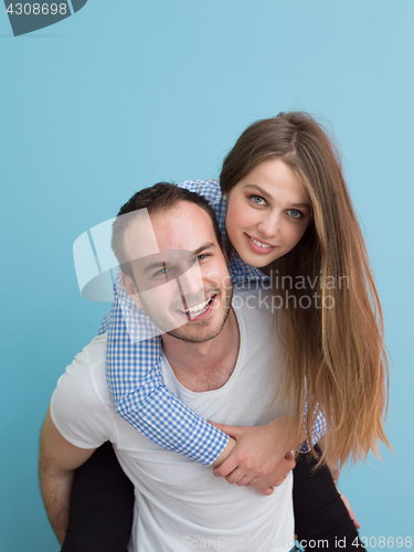 Image of young man piggybacking his girlfriend