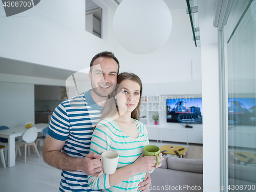 Image of young handsome couple enjoying morning coffee